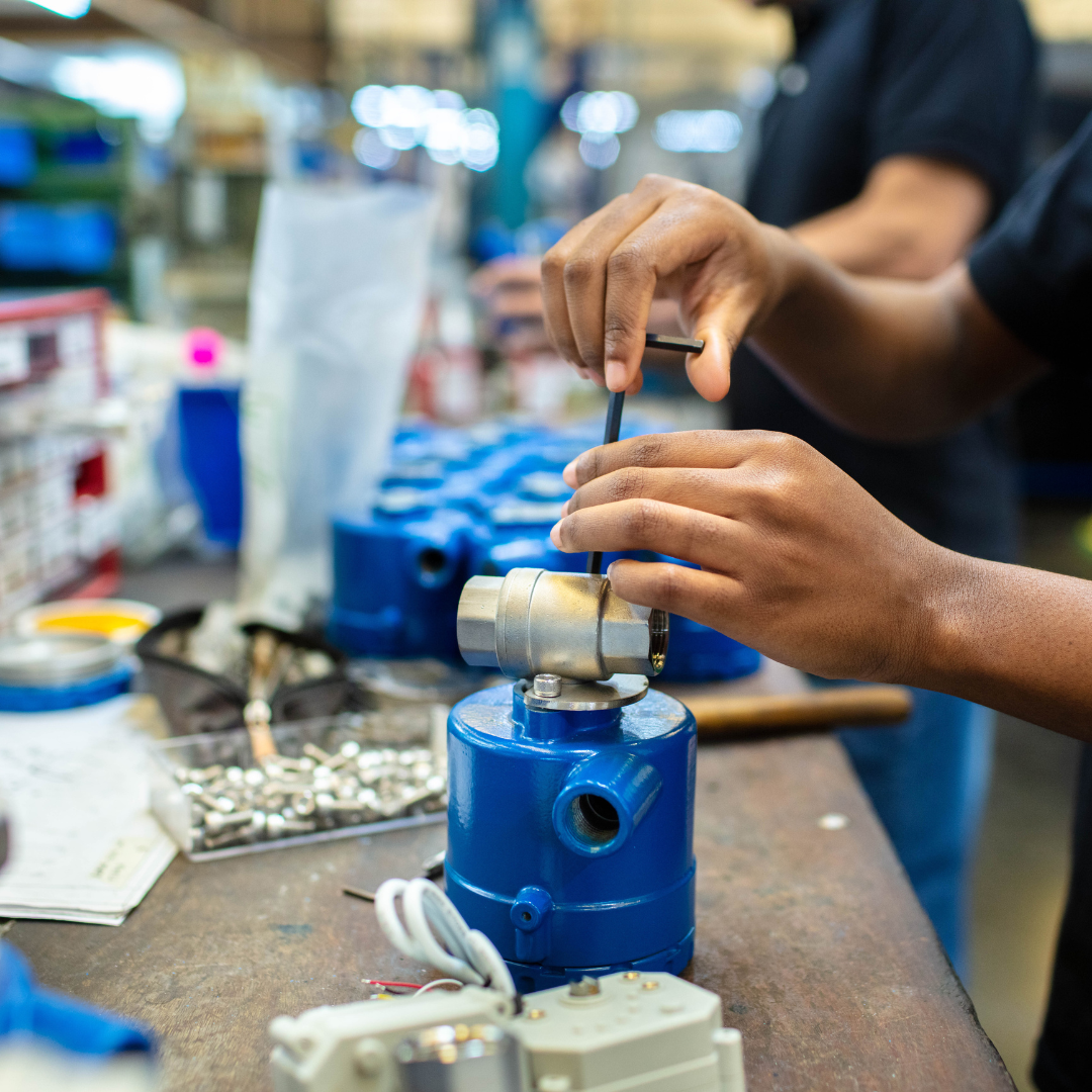 Assembly line worker performing precision assembly